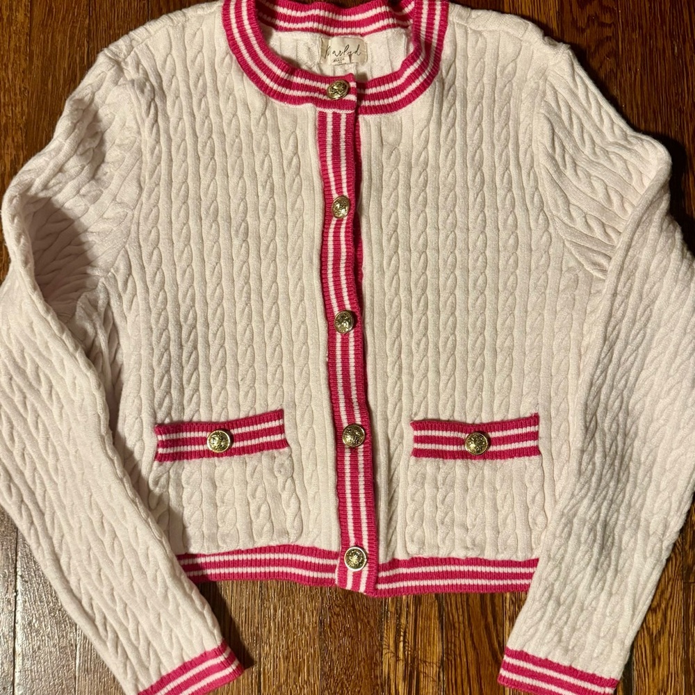 Marled, cable knit cardigan in white with pink trim and gold buttons